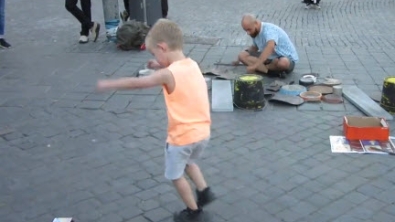 Illustration : "Ce petit garçon est littéralement transporté par les percussions de ce musicien de rue"